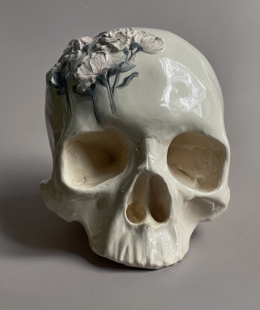 Iteration 3: flowers stuck into the outside of a ceramic skull